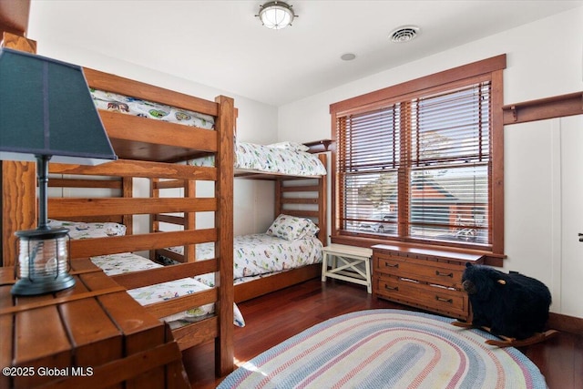 bedroom featuring visible vents and wood finished floors