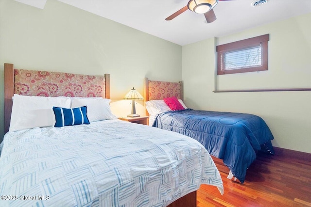 bedroom featuring wood finished floors, baseboards, and ceiling fan