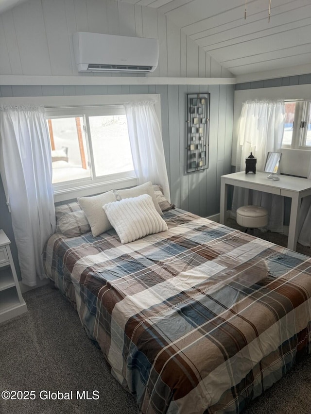 bedroom featuring an AC wall unit and dark carpet