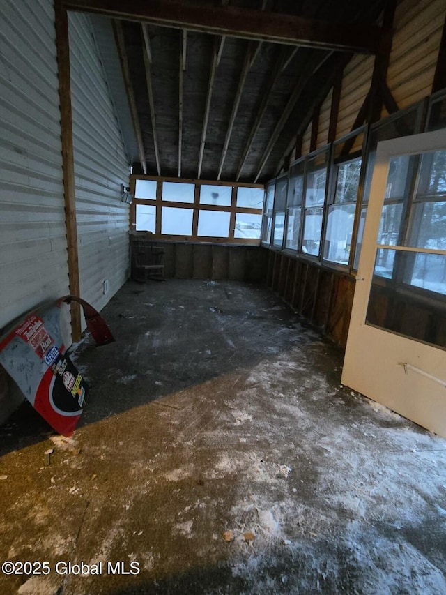 unfurnished sunroom featuring vaulted ceiling