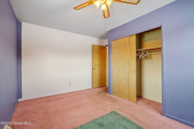 unfurnished bedroom featuring a closet, baseboards, carpet, and ceiling fan