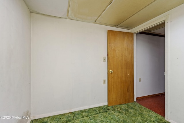 carpeted spare room featuring baseboards