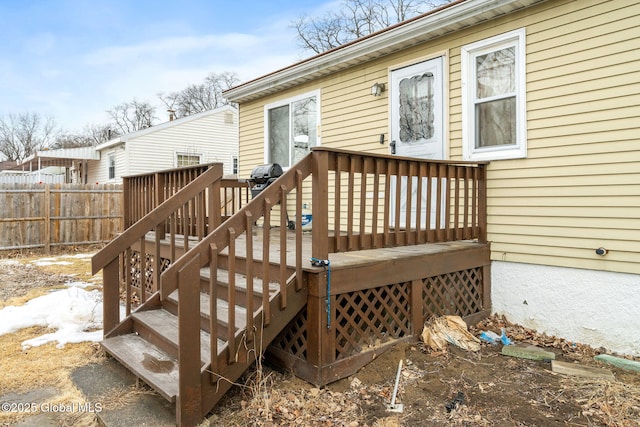 wooden terrace featuring fence