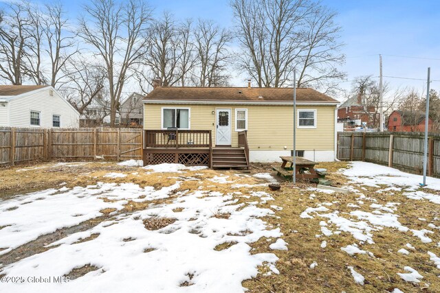 back of house featuring a wooden deck, a fenced backyard, and a chimney