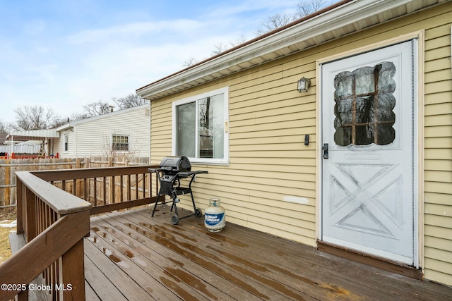 deck featuring area for grilling and fence