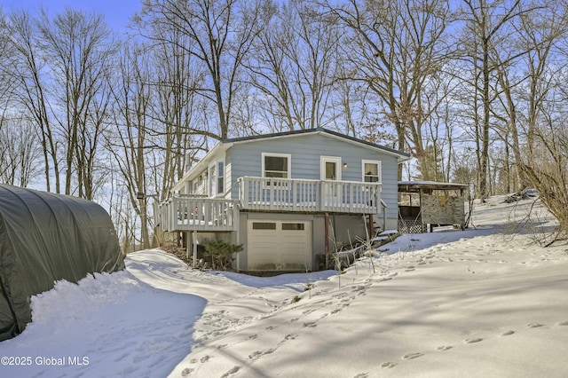 view of front of house with a garage and a wooden deck