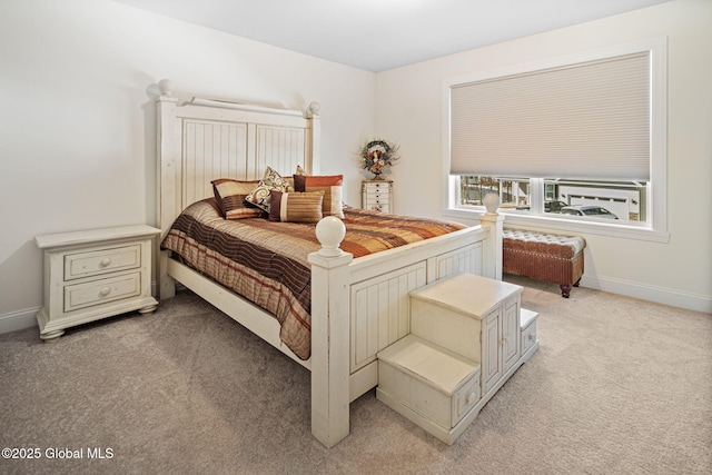 bedroom with light carpet and baseboards