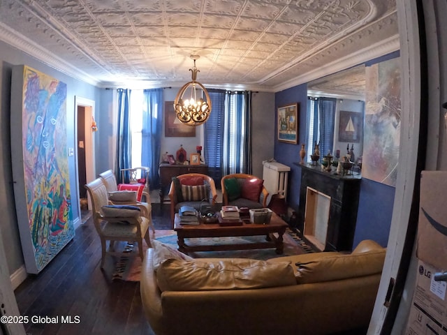 22 Orr St, Troy, NY 12180 - living area with baseboards, an inviting chandelier, crown molding, an ornate ceiling, and wood-type flooring