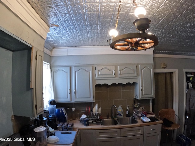 22 Orr St, Troy, NY 12180 - kitchen with crown molding, light countertops, a sink, backsplash, and an ornate ceiling