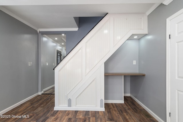 staircase with crown molding, baseboards, and wood finished floors