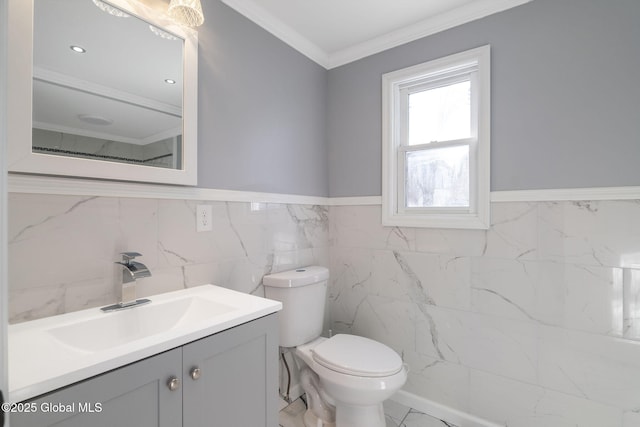 bathroom with toilet, marble finish floor, ornamental molding, and vanity