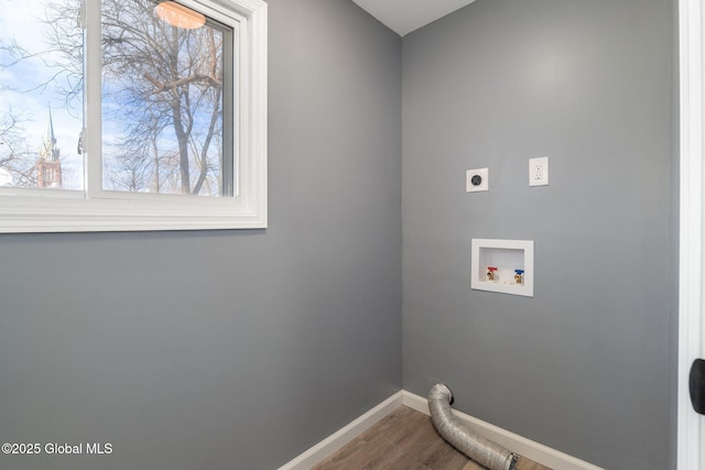 laundry area with hookup for a washing machine, electric dryer hookup, wood finished floors, laundry area, and baseboards