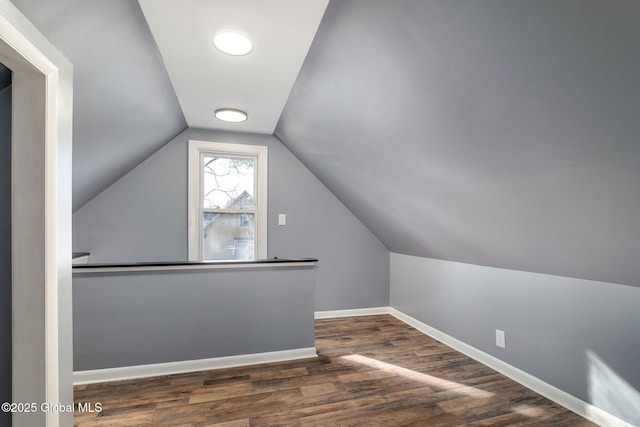 bonus room featuring lofted ceiling, wood finished floors, and baseboards