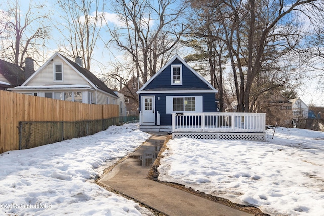 bungalow-style house with fence and a deck