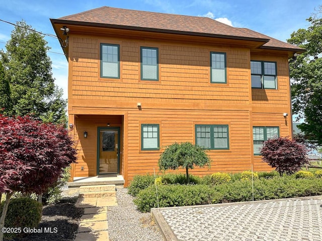 view of front of home featuring roof with shingles