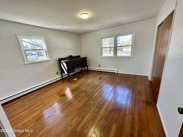 unfurnished bedroom with multiple windows, dark wood-type flooring, and baseboards