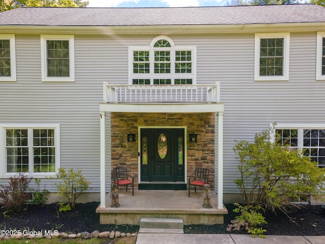 76 Barney Rd, Greenfield, NY 12850 - doorway to property with stone siding, a balcony, and roof with shingles