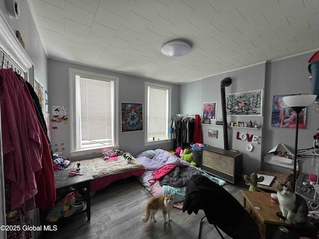 bedroom featuring crown molding and wood finished floors