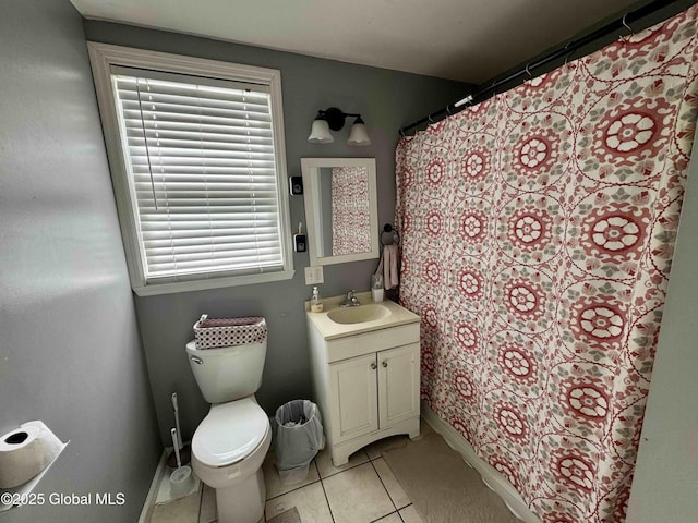 bathroom with toilet, baseboards, vanity, and tile patterned floors