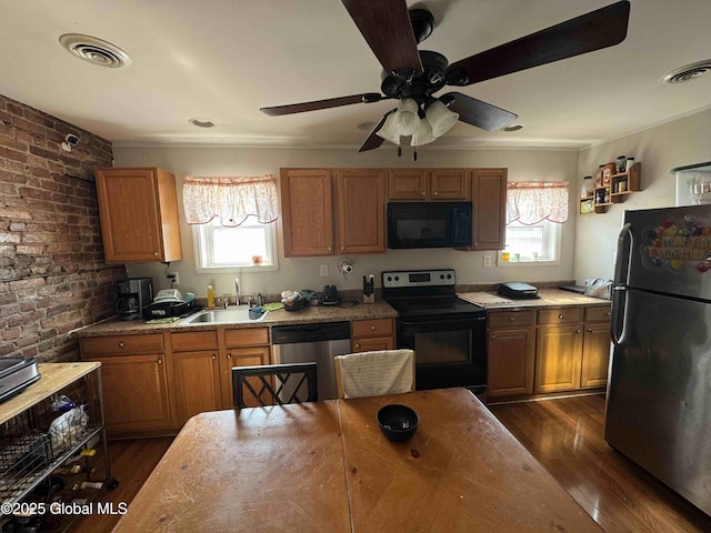 kitchen featuring plenty of natural light, visible vents, a sink, and black appliances