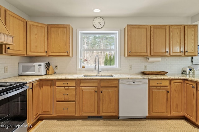 kitchen with custom range hood, decorative backsplash, a sink, light stone countertops, and white appliances