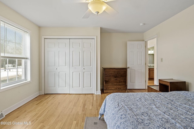 bedroom featuring ceiling fan, visible vents, baseboards, a closet, and light wood-type flooring