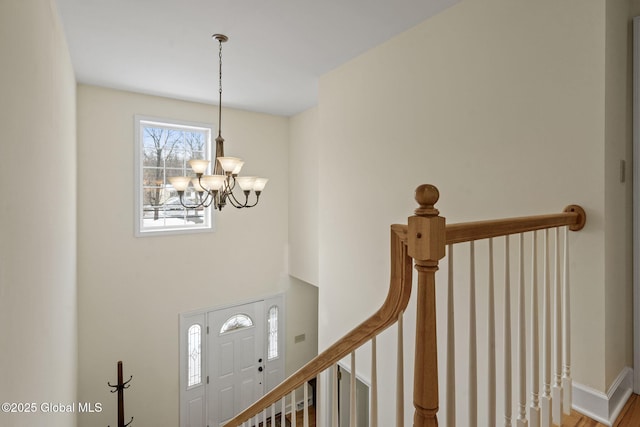 foyer entrance with a chandelier