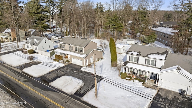 snowy aerial view with a residential view