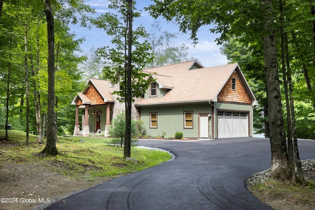 view of front of home featuring driveway and a shingled roof