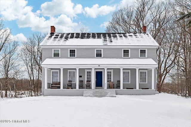 view of front of home with a porch and a chimney