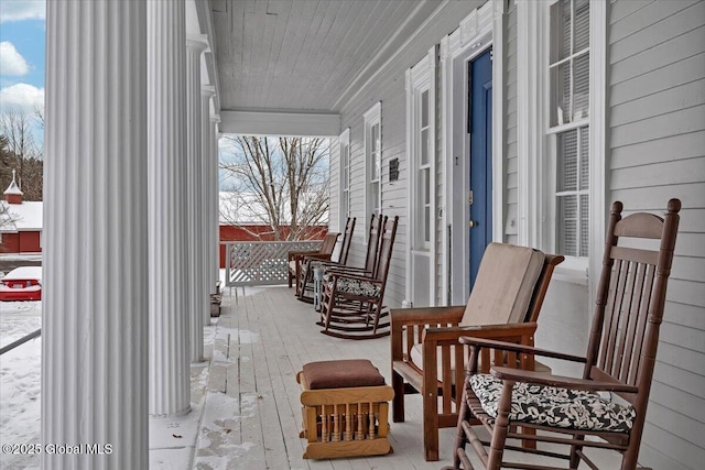 snow covered patio with covered porch