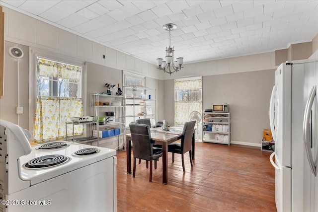 dining space featuring an inviting chandelier and wood finished floors