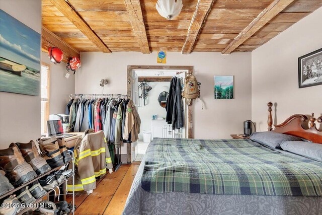 bedroom with light wood-type flooring, wood ceiling, and beamed ceiling