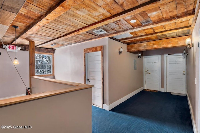 below grade area with wood ceiling, visible vents, baseboards, and dark carpet