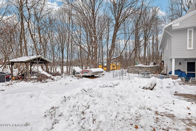 yard layered in snow with a garage