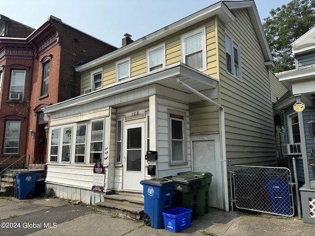 view of front of property featuring entry steps and a chimney