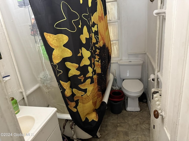 bathroom with tile patterned flooring, vanity, and toilet