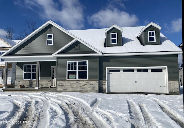 view of front of home with a garage, stone siding, and a porch