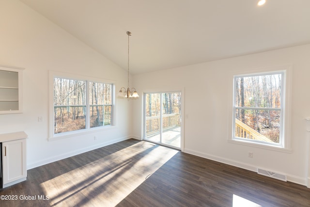 unfurnished dining area featuring dark wood-style flooring, a notable chandelier, lofted ceiling, visible vents, and baseboards