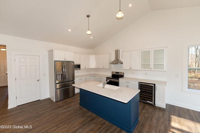 kitchen featuring wine cooler, decorative light fixtures, stainless steel appliances, wall chimney range hood, and glass insert cabinets