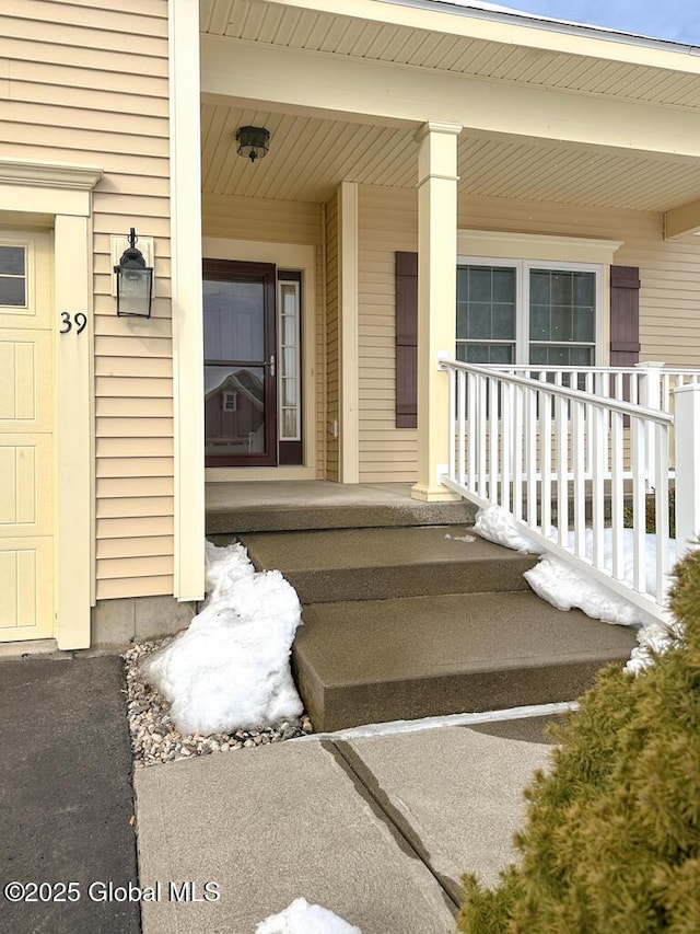 view of exterior entry with a porch