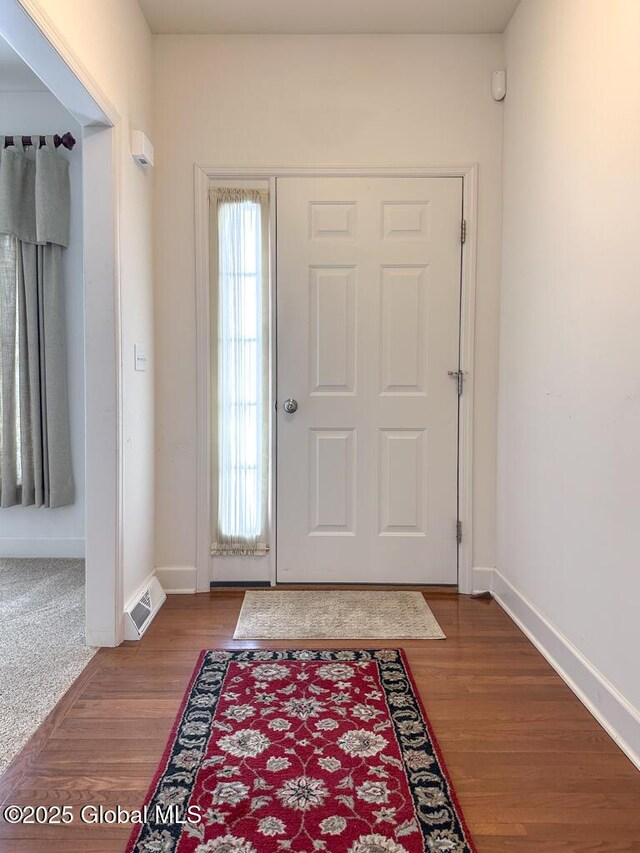 entrance foyer featuring wood finished floors, visible vents, and baseboards