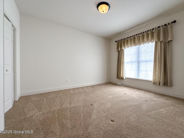 empty room with carpet floors and baseboards