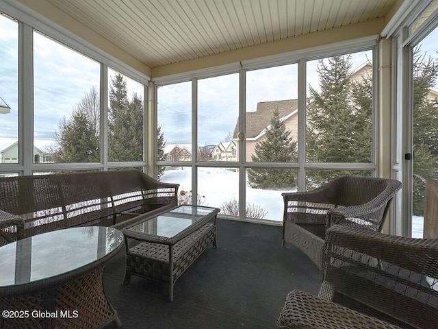 sunroom / solarium featuring a water view