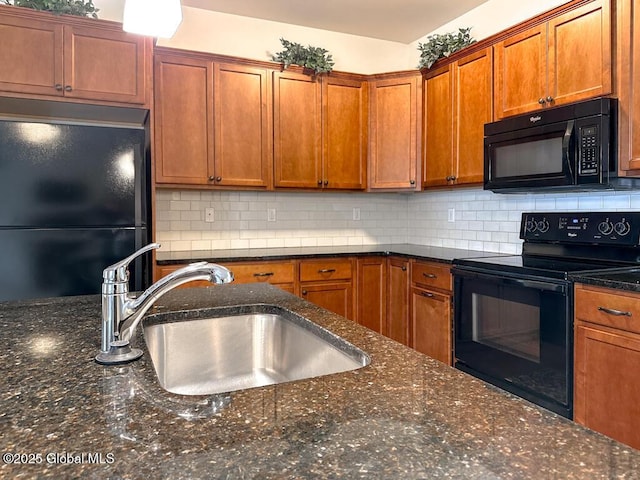 kitchen with dark stone counters, brown cabinets, a sink, black appliances, and backsplash