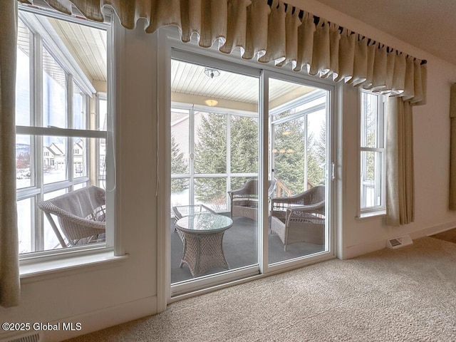 entryway featuring visible vents and carpet flooring