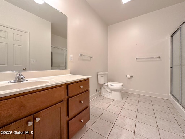 full bathroom featuring toilet, a shower stall, vanity, and tile patterned floors