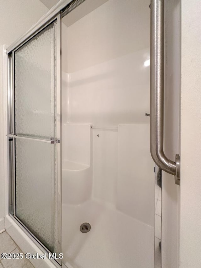 bathroom with a shower with shower door