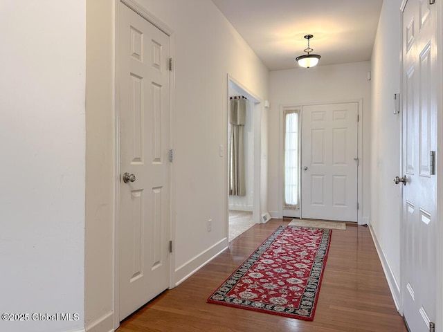 entrance foyer featuring baseboards and wood finished floors