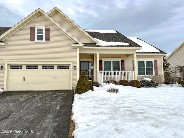 view of front of property featuring covered porch, driveway, and an attached garage